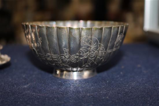 A Chinese silver sugar bowl and two tea strainers.
